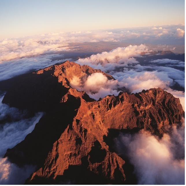 Piton des Neiges summit rising above the clouds at sunrise, Reunion Island