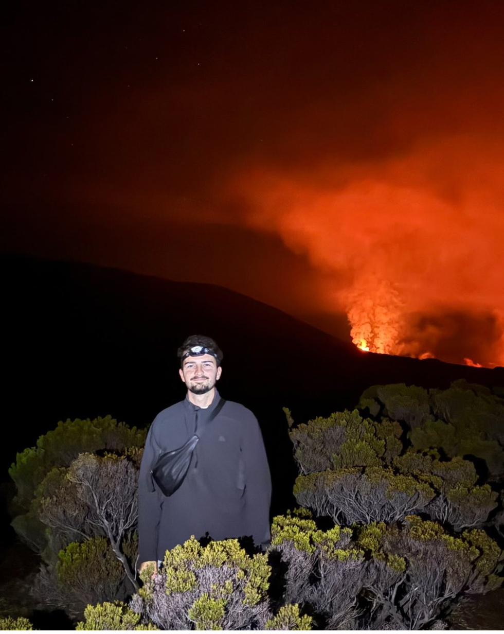 Carlos watching Piton de la Fournaise volcano erupting at night, Reunion Island
