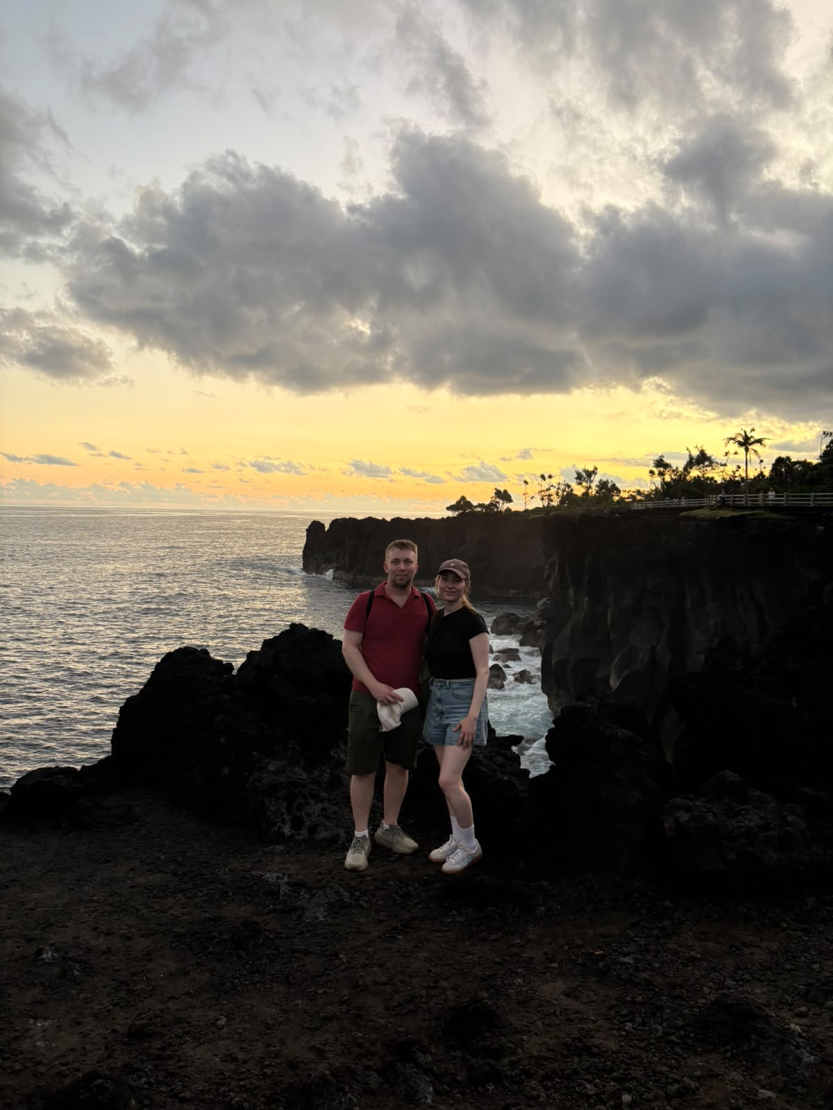 Heidi and Aku at a coastal cliff viewpoint at sunset, Reunion Island